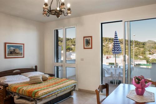 a bedroom with a bed and a dining room with a table at La Torre in Santa Cesarea Terme