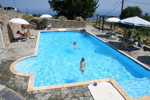 a person swimming in a swimming pool at Hotel Vrionis in Agios Dimitrios