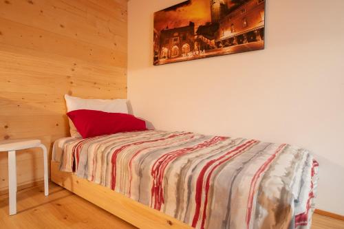 a bedroom with a bed with a red pillow at Agriturismo La Soglia Del Parco in Ranica