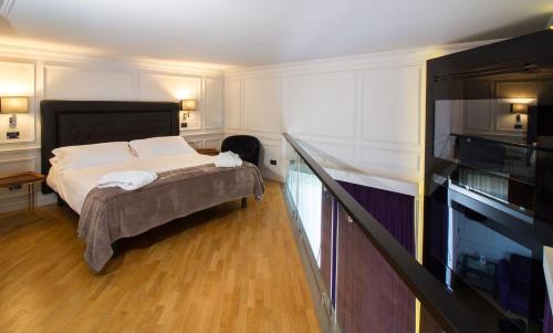 a bedroom with a bed and a flat screen tv at Hotel Europa in Taranto