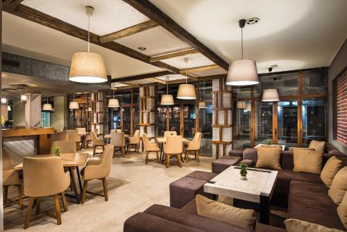 a restaurant with couches and tables and chairs at SPA complex Elena in Elena