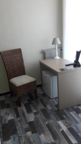 an office with a desk and a chair and a lamp at Hotel de la Plage - Barcares in Le Barcarès