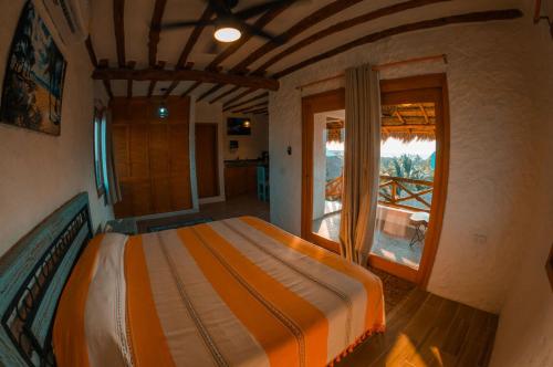 Säng eller sängar i ett rum på Ensueño Holbox & Beach Club