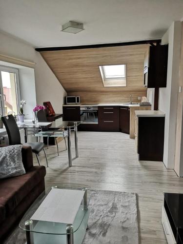 a large living room with a couch and a table at Malinowa 36 Apartamenty in Chojnice