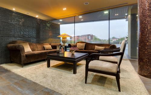 a living room with a couch and a table at Iberik Santo Domingo Plaza Hotel in Oviedo