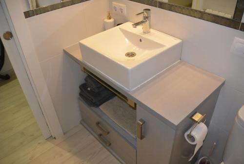 a bathroom with a white sink and a counter at APARTAMENTO CENTRICO in Santander