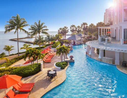a pool at a resort with palm trees and umbrellas at Jewel Grande Montego Bay Resort and Spa in Montego Bay