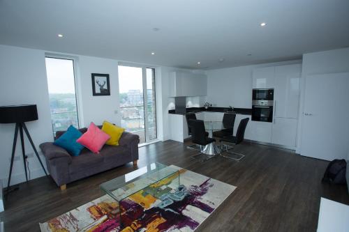 a living room with a couch and a table at HIGH VIEW TWO BEDROOM APARTMENT IN WOOLWICH in London