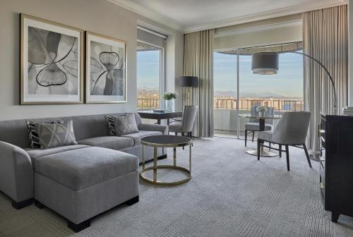 a living room with a couch and a table at Four Seasons Hotel Los Angeles at Beverly Hills in Los Angeles