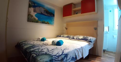 a bedroom with a bed with two pillows on it at Mobile home Lučan in Drage