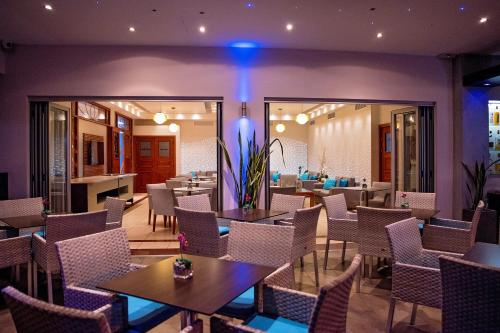 a restaurant with tables and chairs in a room at Pyramos Hotel in Paphos City