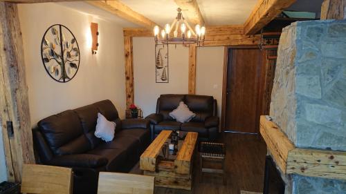 a living room with a couch and a table at Plitvički San in Korenica