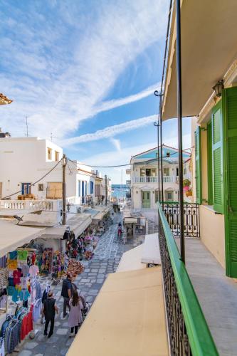 a view from a balcony of a street with shops at Tinos La belle vie in Tinos