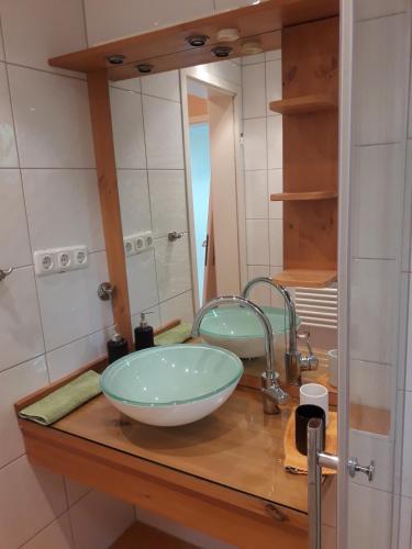 a bathroom with a bowl sink and a mirror at Haus Bergreich in Schönau am Königssee