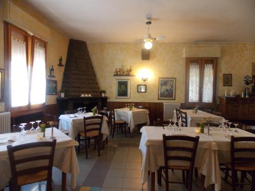 a restaurant with tables and chairs with white table cloth at Hotel Ristorante La Bettola in Sasso Marconi