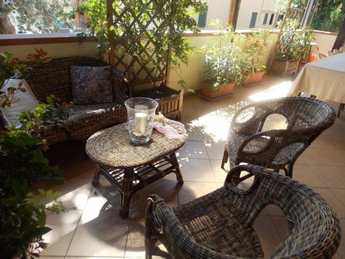 a patio with a table and chairs and a couch at Hotel Ristorante La Bettola in Sasso Marconi