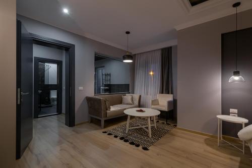 a living room with a couch and a table at Barba Boutique Hotel in Korçë