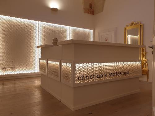 a room with a counter with lights on the wall at Christian's Suites & Spa in Fasano