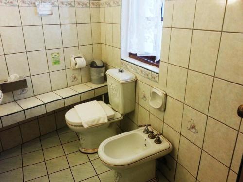 a bathroom with a toilet and a sink at Dolce Vita Hotel in Puerto Princesa City