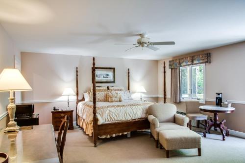 a bedroom with a bed and a chair at Boxwood Lodge Blowing Rock near Boone-University in Blowing Rock