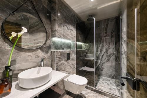 a bathroom with a sink and a toilet and a shower at Royal Suites-Sky in Split