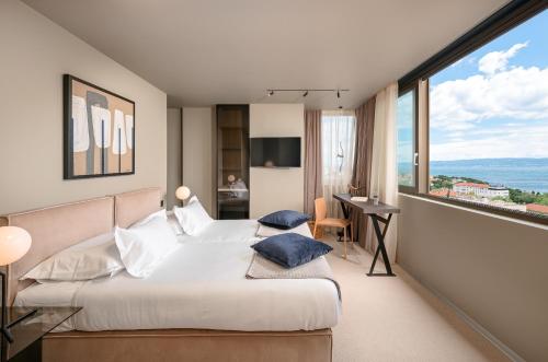 a hotel room with two beds and a desk at Royal Suites-Sky in Split