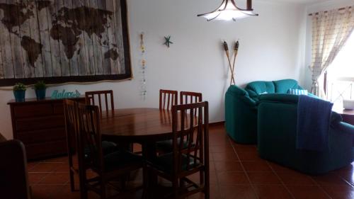 sala de estar con mesa y sofá en West House Peniche Consolação Apartment, en Peniche