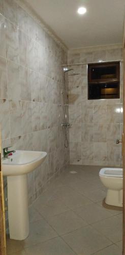 a bathroom with a sink and a toilet at Lantana Comfy in Kakamega