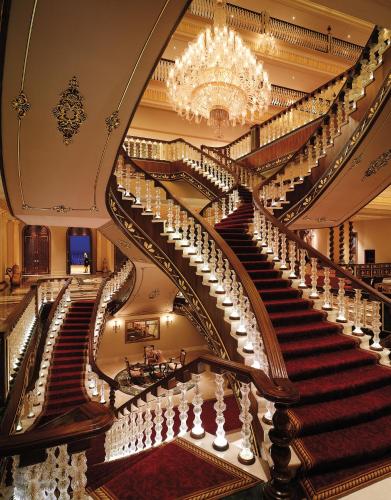 a large staircase in a building with a chandelier at Titanic Mardan Palace in Lara