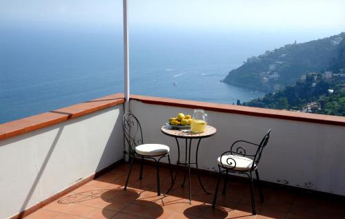 a balcony with a table with a bowl of fruit at Hotel Villa Felice Relais in Amalfi