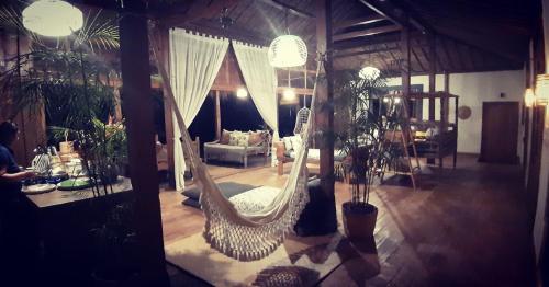 a living room with a hammock in a room at Bali Beach Eco Villas Pondok Matekap in Selemadeg