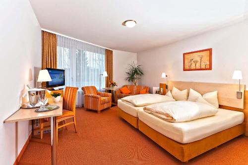 En eller flere senger på et rom på Hotel Sonnengarten