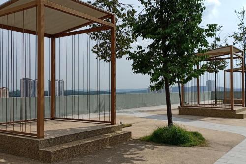 a pavilion with a tree in a park at Manee Home Kota Damansara in Kuala Selangor