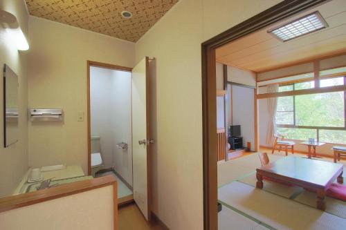 a living room with a table and a dining room at Kounso in Yamanakako