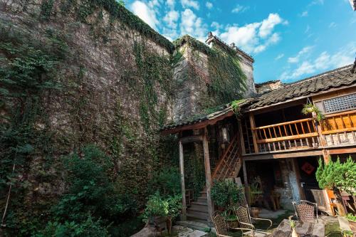 an old building with ivy on the side of it at Old Street Xi'an Inn (Free Pick up Service) in Huangshan