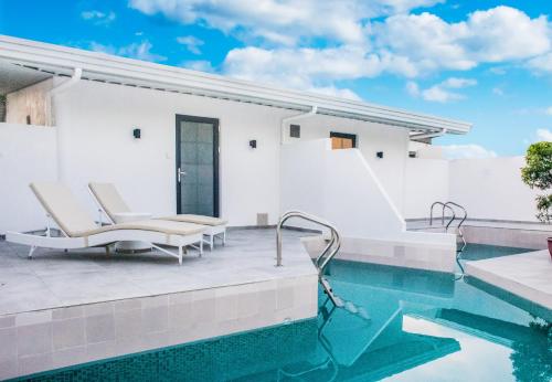 a house with a swimming pool and a patio at Marina Point Bay Resort in Panglao