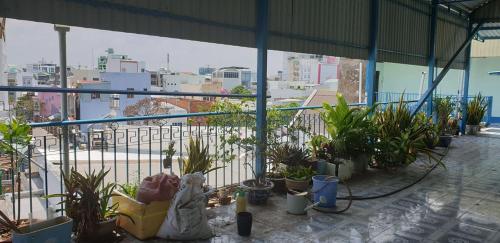 a balcony with plants and a view of a city at Nhà Trọ Kim Ánh in Long Xuyên