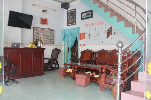 a living room with a stair case and a stair railing at Huỳnh Hương Guesthouse in Ha Tien