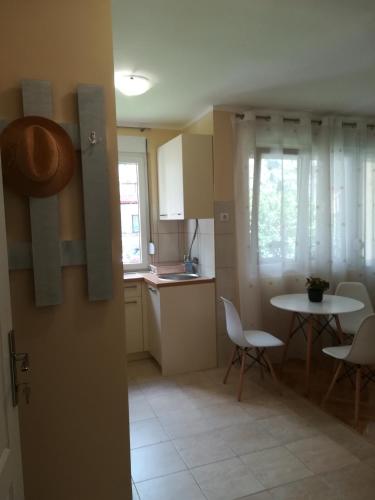 a kitchen and dining room with a table and chairs at Apartment Nikolic Kotor in Kotor