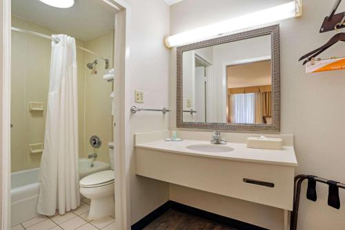a bathroom with a sink and a toilet and a mirror at Quality Inn Baton Rouge East I-12 in Baton Rouge