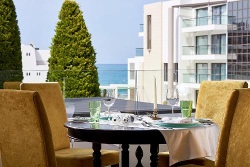 
a dining room table set up with chairs at Albatros Spa & Resort Hotel in Hersonissos
