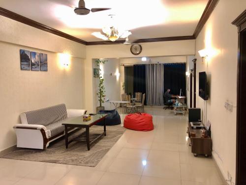 
a living room filled with furniture and a couch at Backpackers Hostel & Guest house Islamabad in Islamabad
