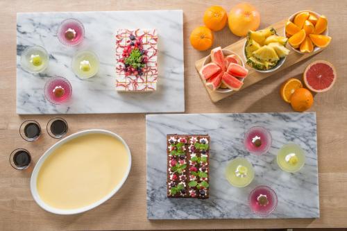 a table topped with fruit and a bowl of liquid at KAMENOI HOTEL Beppu in Beppu