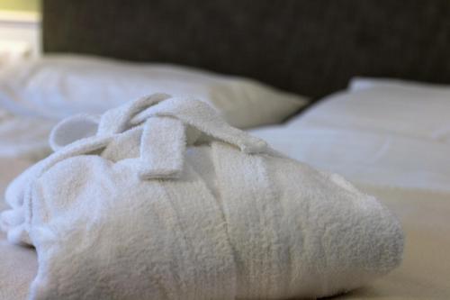 a white towel sitting on top of a bed at Villa Bucher - Metnitztalerhof in Friesach