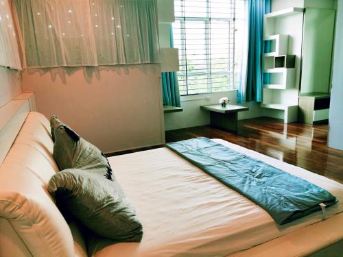 a bedroom with a large bed with pillows on it at MiCasa 2 Homestay in Sibu