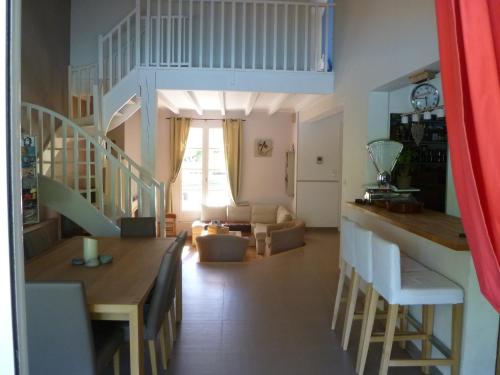 a kitchen and living room with a staircase and a living room at Villa familiale aux portes du Médoc et de Bordeaux in Blanquefort