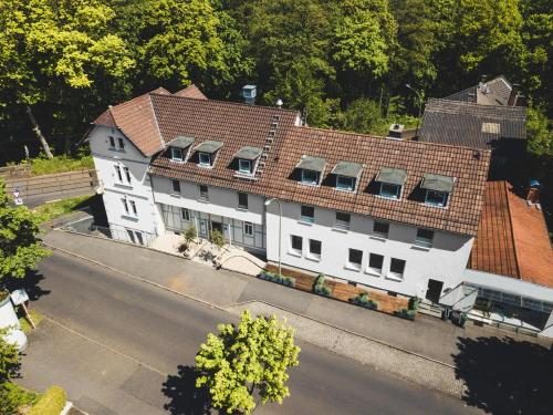 an overhead view of a white building with a red roof at Hotel Palmenbad in Kassel