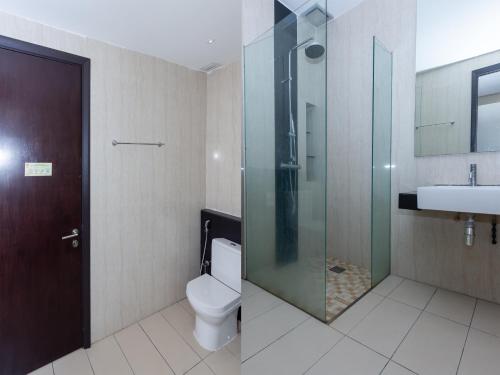 a bathroom with a toilet and a glass shower at MIO BOUTIQUE Hotel in Melaka