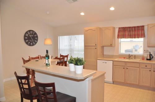 a kitchen with a table and a clock on the wall at The Oasis in Orlando