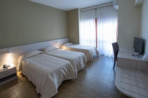 Ένα ή περισσότερα κρεβάτια σε δωμάτιο στο Hotel Scacciapensieri